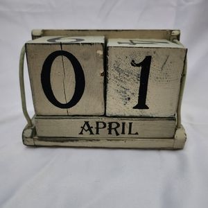 Wooden block desktop calendar. Cream colored with a distressed look.